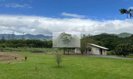 Sítio com 22.000 m², com duas casas, riacho cristalino, escriturada, frente para rua pavimentada