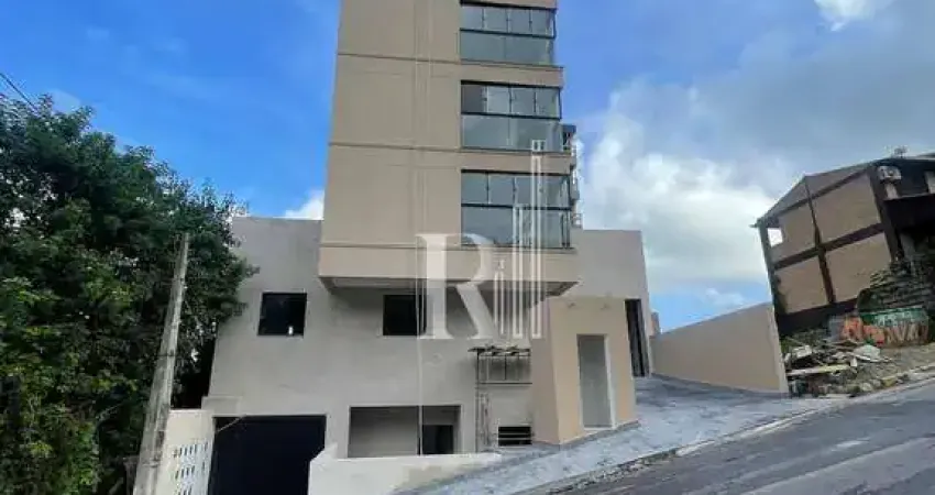 Apartamento à venda com living integrado, 2 dormitórios sendo uma suíte e vaga de garagem coberta,