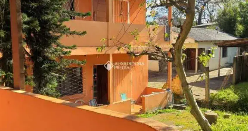 Casa com 4 quartos à venda na Avenida Vicente Monteggia, 283, Cavalhada, Porto Alegre