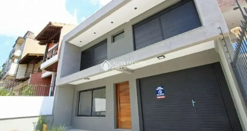 Casa em condomínio fechado com 3 quartos para alugar na Rua Buarque de Macedo, 931, São Geraldo, Porto Alegre