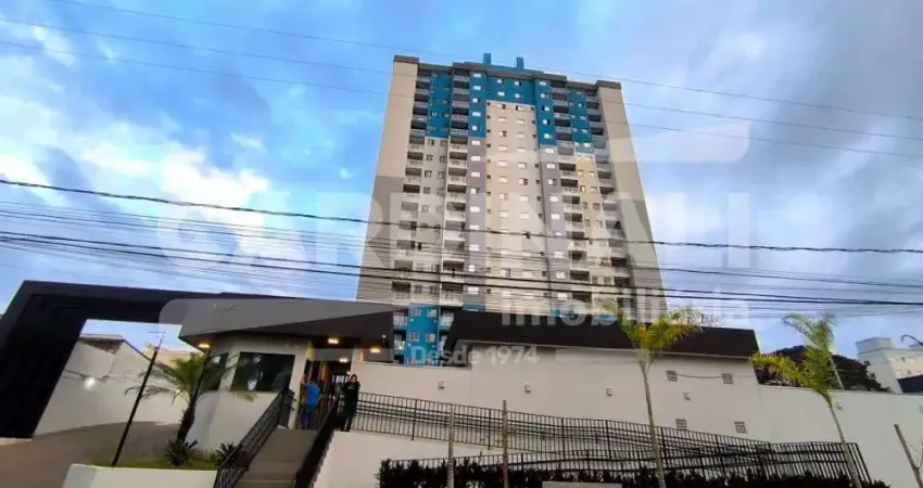 apartamento de dois dormitórios com uma vaga de garagem.