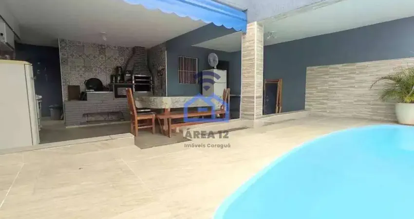 Casa com piscina e área gourmet à venda no bairro do Indaiá em Caraguatatuba, SP