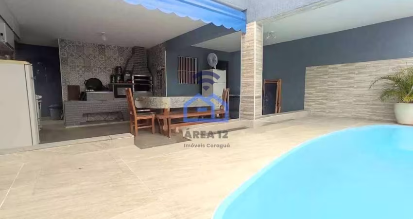 Casa com piscina e área gourmet à venda no bairro do Indaiá em Caraguatatuba, SP