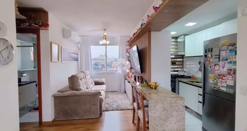 Apartamento 2 dormitórios, uma suíte, 1 vaga de garagem, living com churrasqueira, mobiliado com móveis planejados.