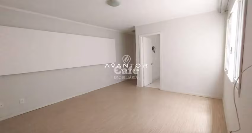 Apartamento central com 3 dormitórios, espaço gourmet e box garagem.